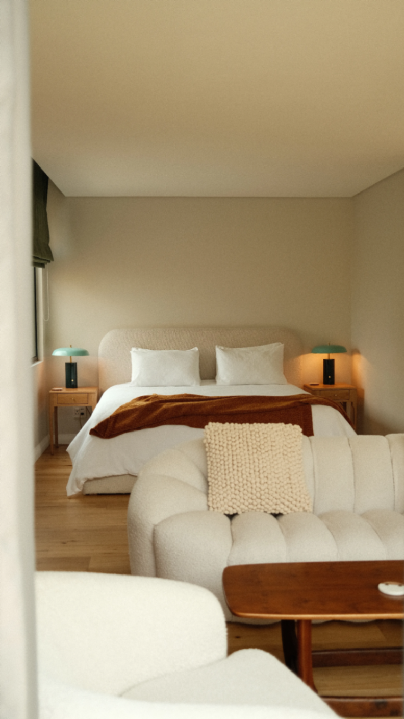 Suite layered in cream textiles and warm oak