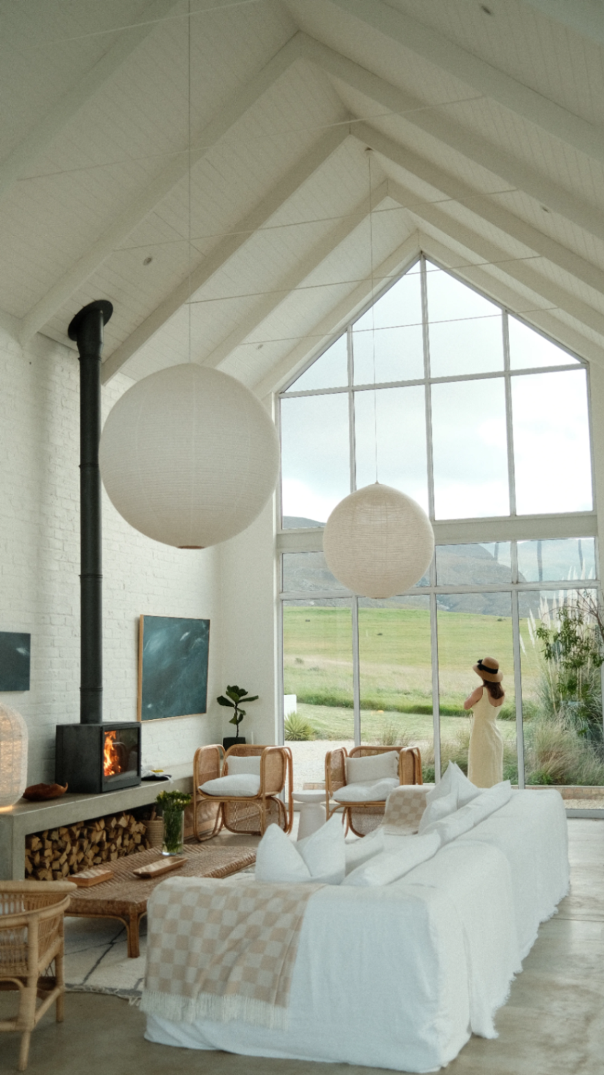 Living room hearth beneath the pitched white ceiling