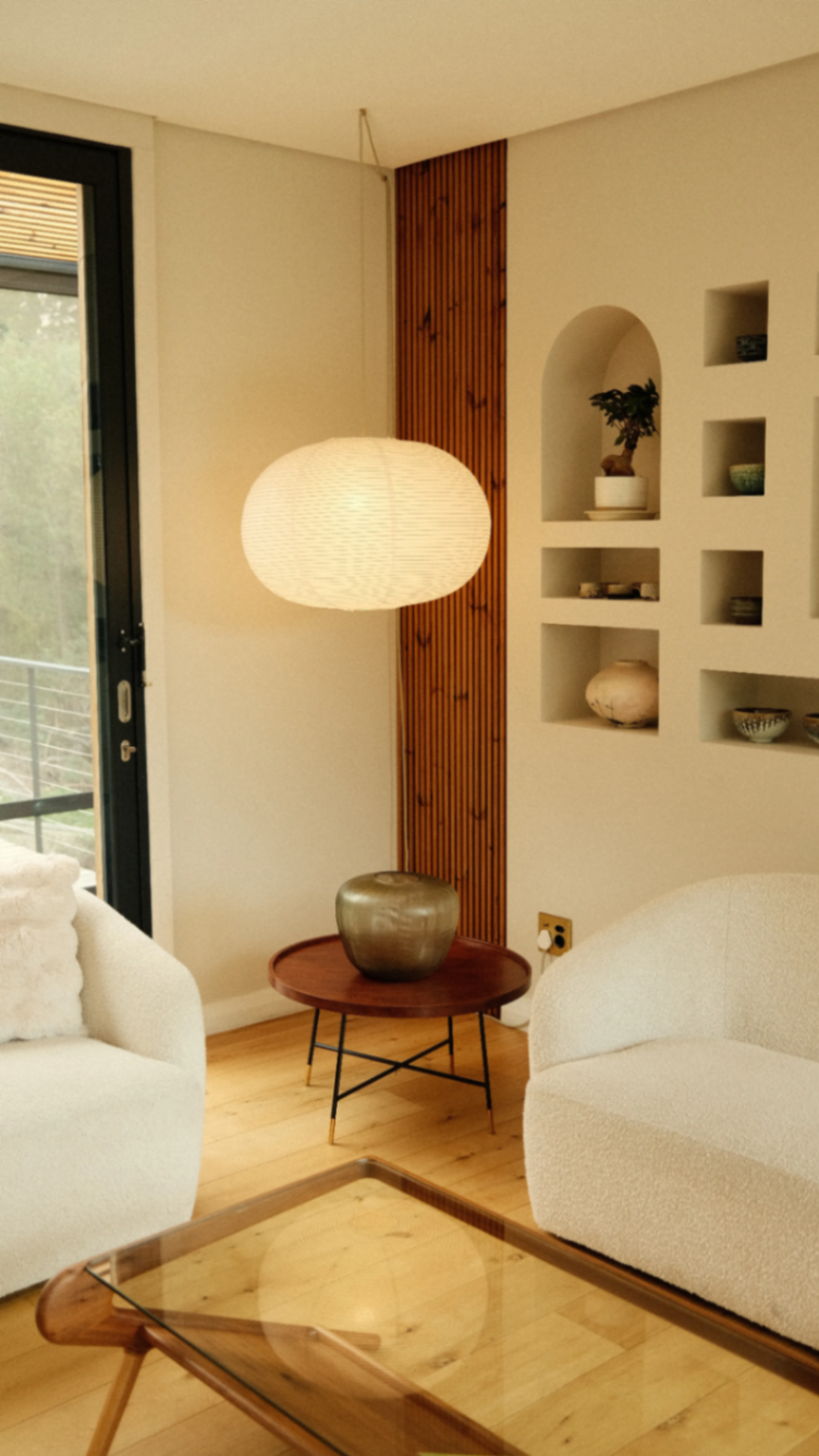 Lounge with bouclé seating and paper lantern glow