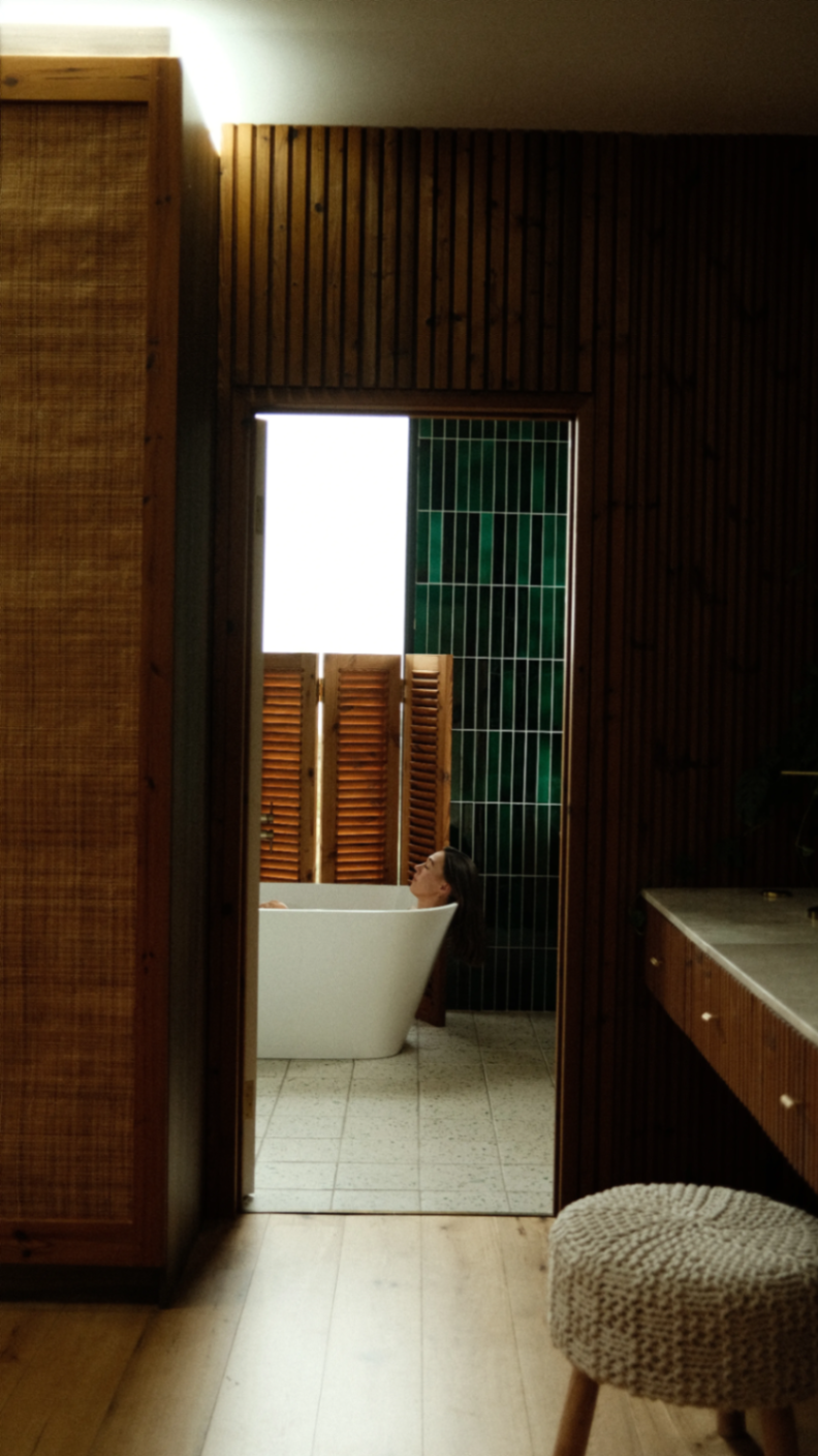 Bath ritual seen through the timber-lined suite